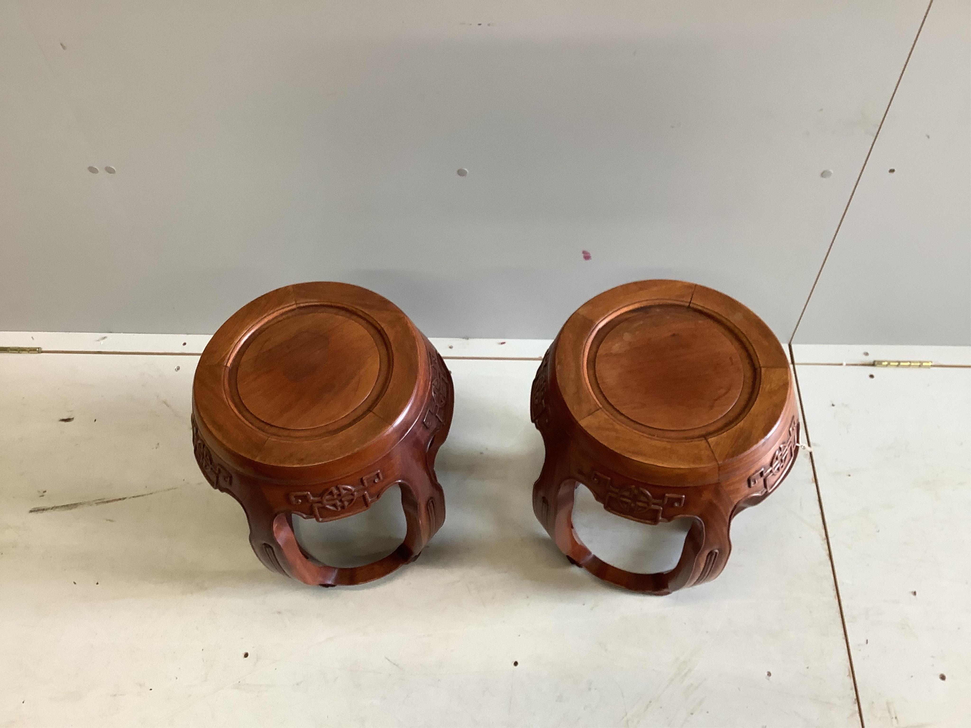 A pair of Chinese carved hardwood jardiniere stands, diameter 38cm, height 46cm. Condition - good